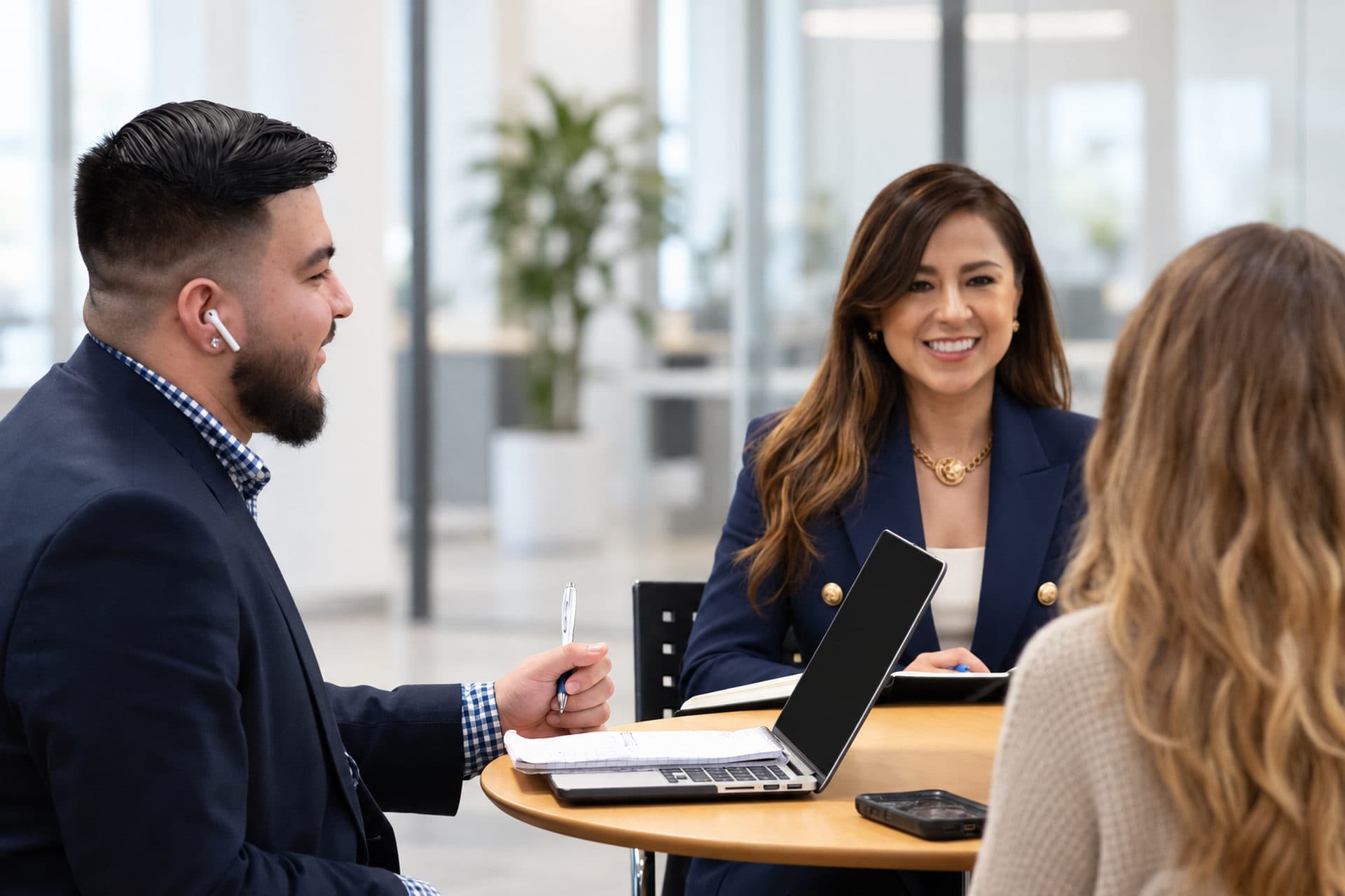 Janel Garcia in conversation with colleagues around a table in the TriQuest office